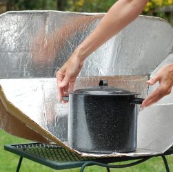 someone using a solar cooker
