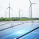 Wind turbines and solar panels in a modern renewable energy field under soft overcast daylight.